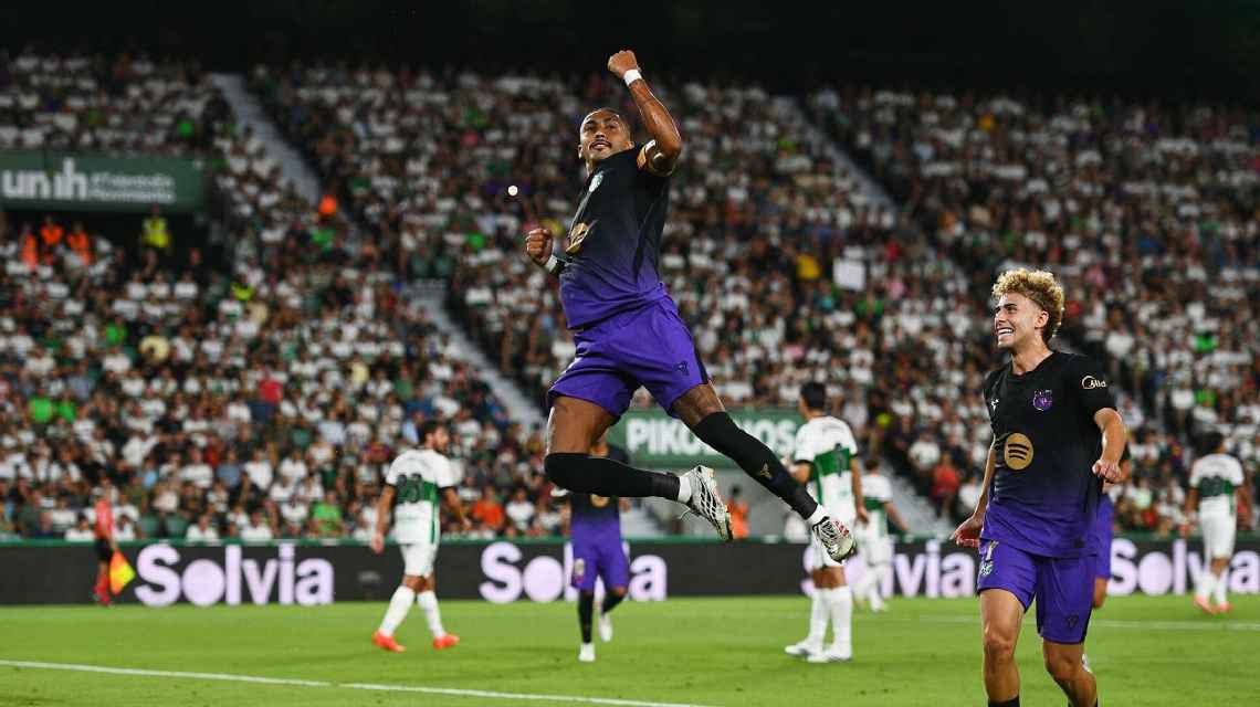 Raphinha leaps in the air celebrating a goal for Barcelona during the 5-0 La Liga win at Elche