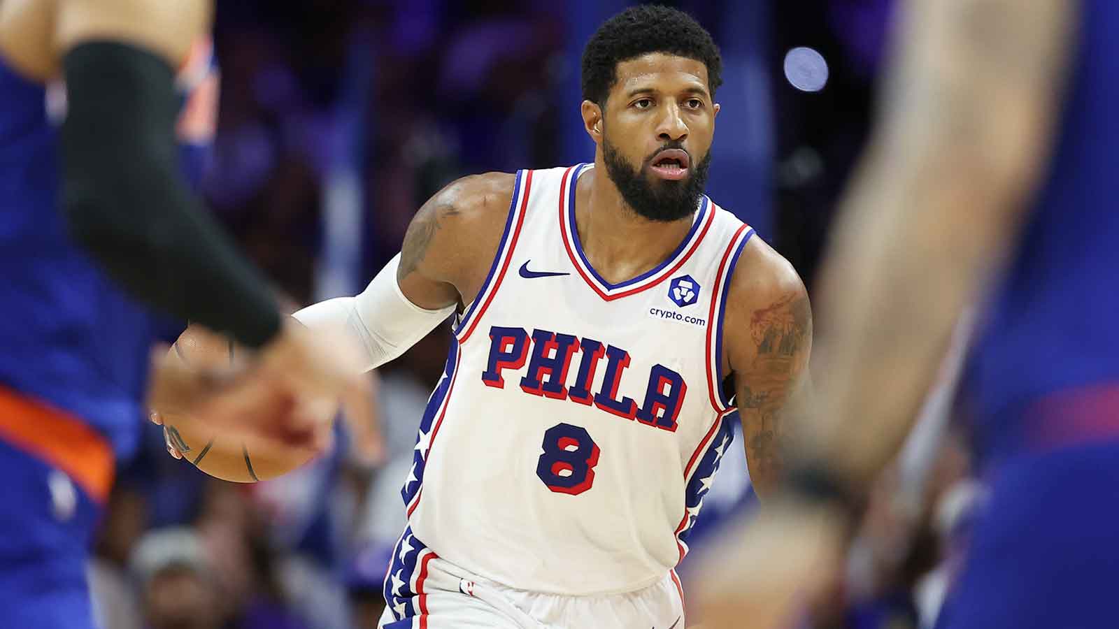 Paul George drives to the basket in a white Philadelphia 76ers No. 8 jersey.