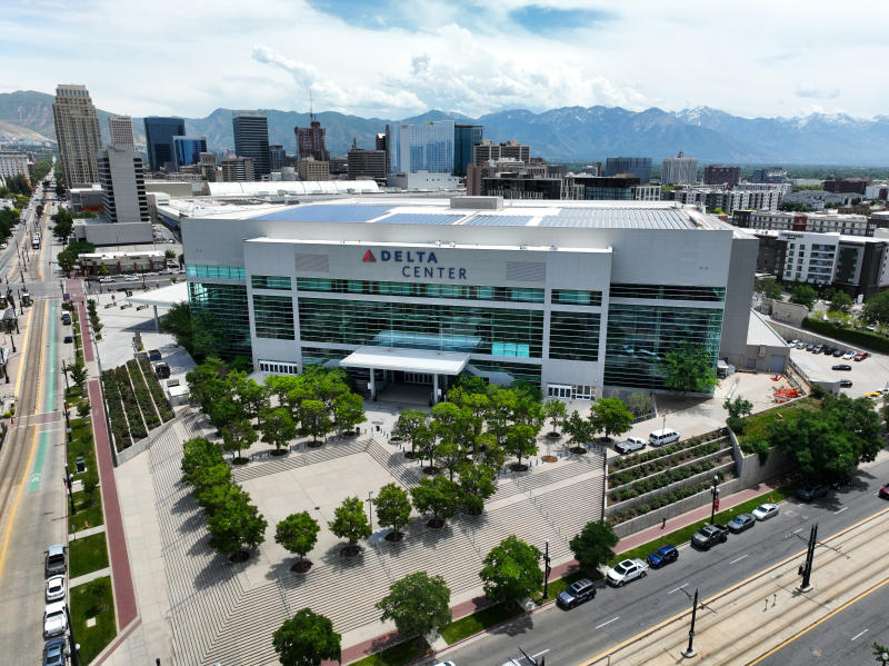 Aerial view of the Delta Center arena in downtown Salt Lake City with the Wasatch mountains behind