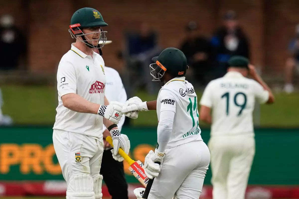 South Africa's Simon Harmer celebrates his 50 runs with captain Temba Bavuma on day three of the second Test against Australia at St George's Park, Gqeberha (AP Photo/Themba Hadebe)