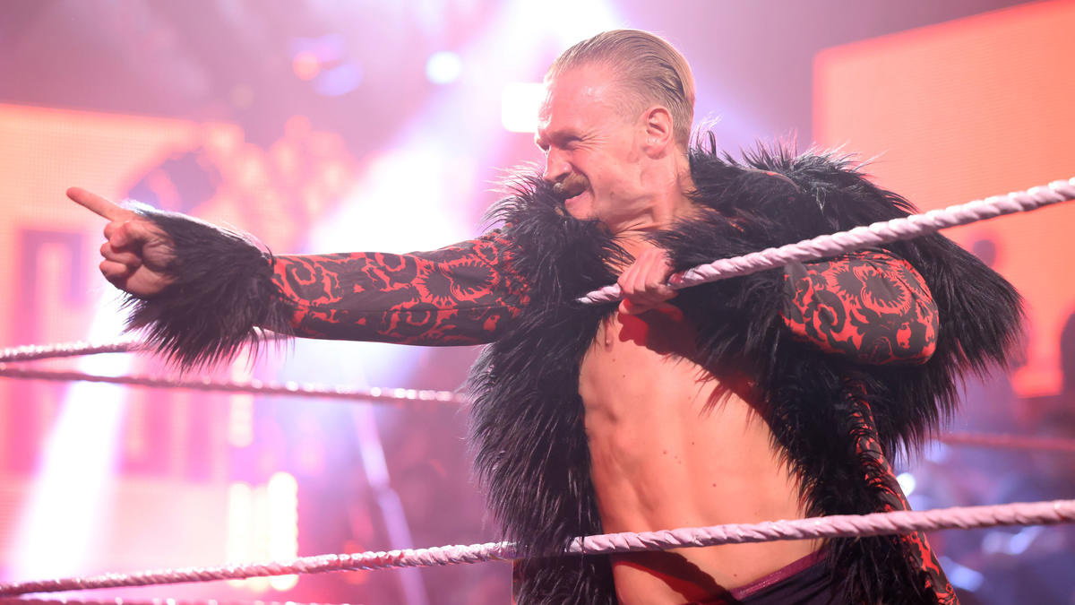 Ilja Dragunov in the ring in black and red gear during his WWE run, pointing at the crowd