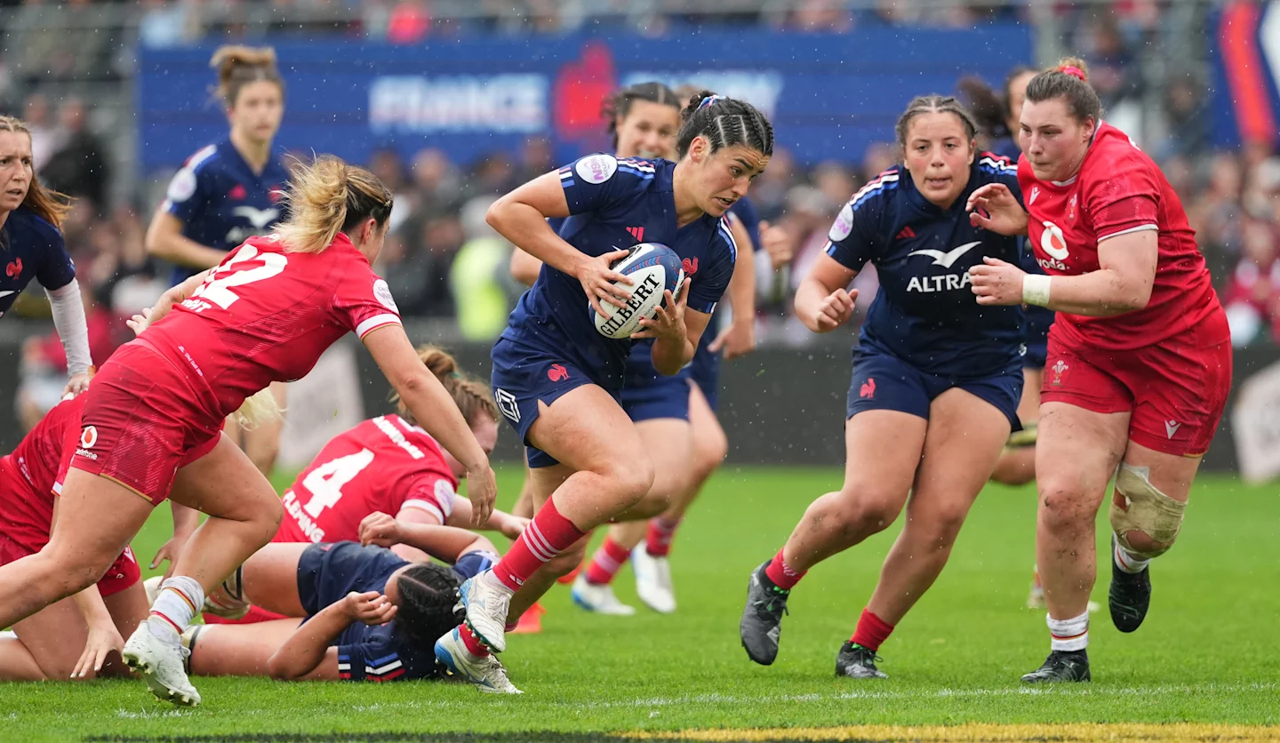 France women's players attacking during a Six Nations match against Wales