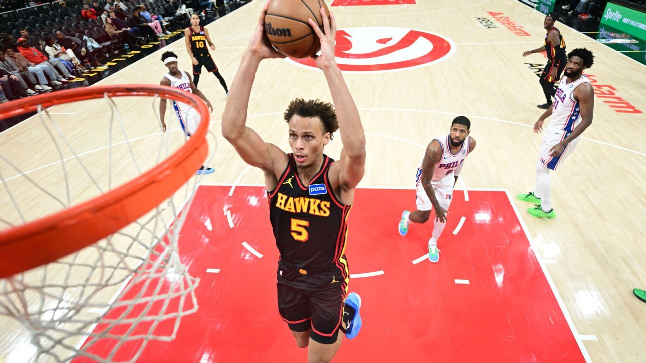 Dyson Daniels soars for a dunk in his black Atlanta Hawks No. 5 jersey