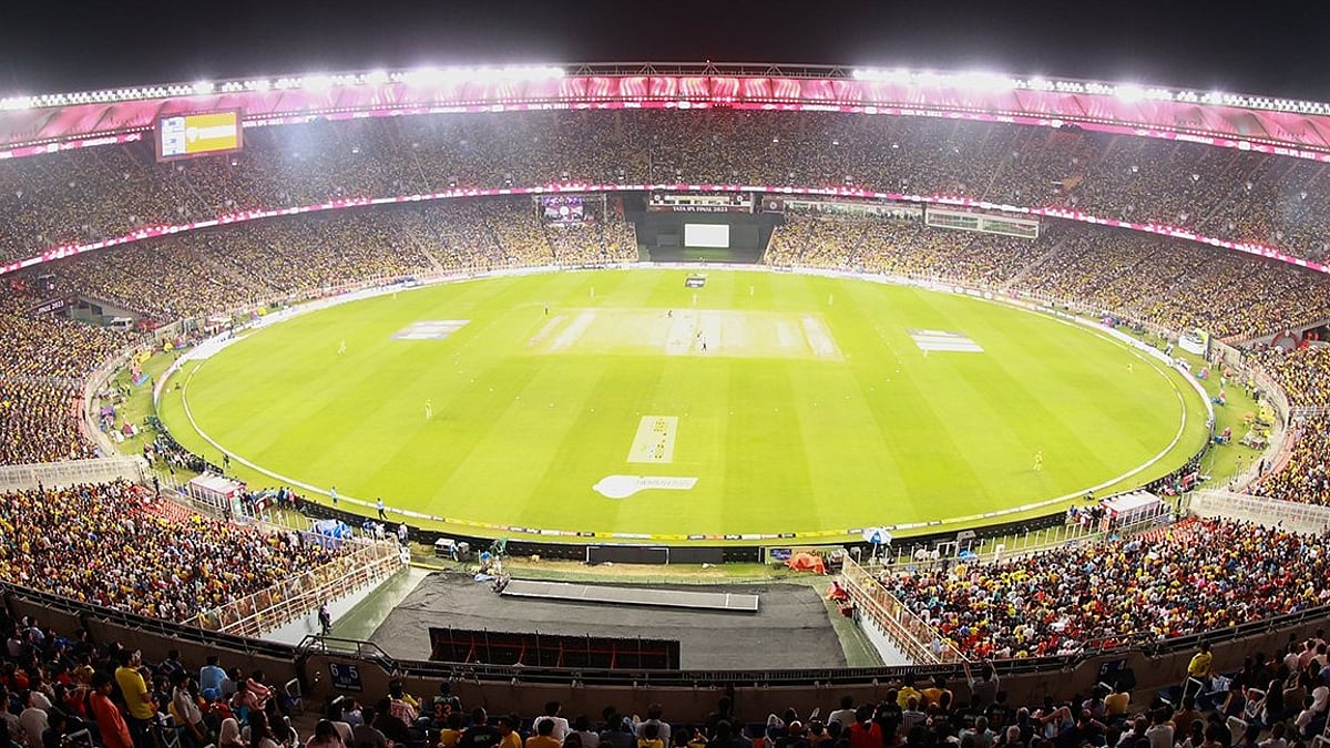 Cricket stadium under floodlights during a night match