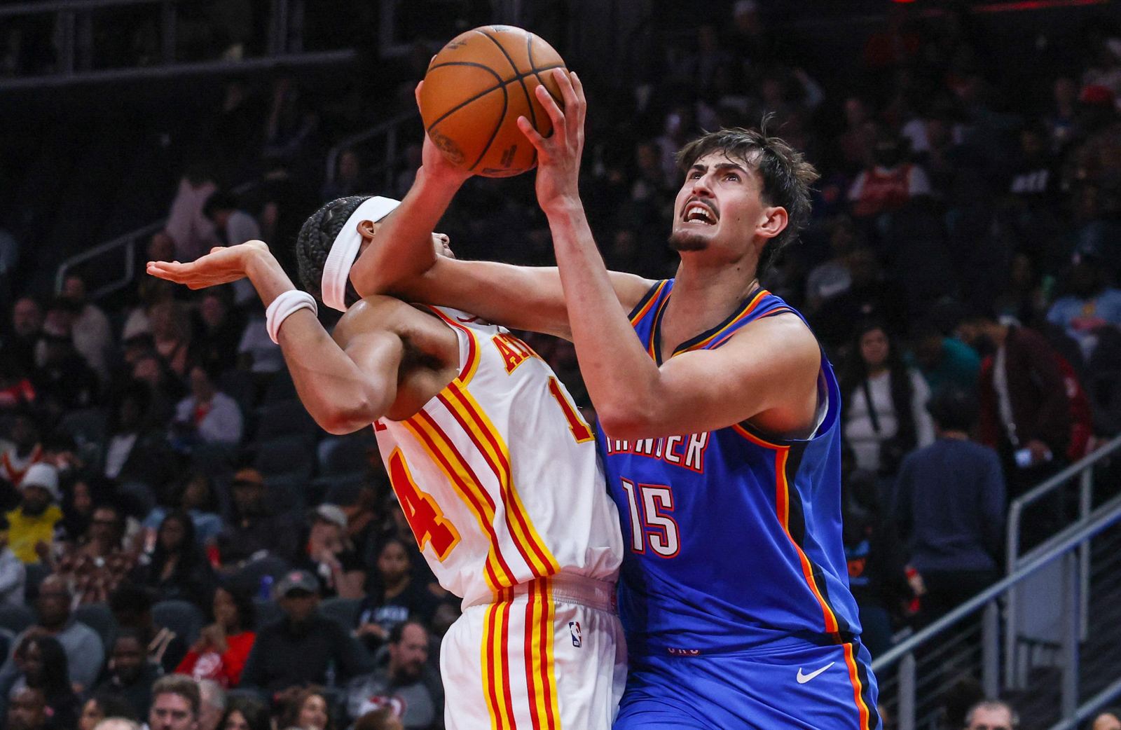 Oklahoma City Thunder rookie center Aday Mara drives against Atlanta Hawks forward Asa Newell during preseason