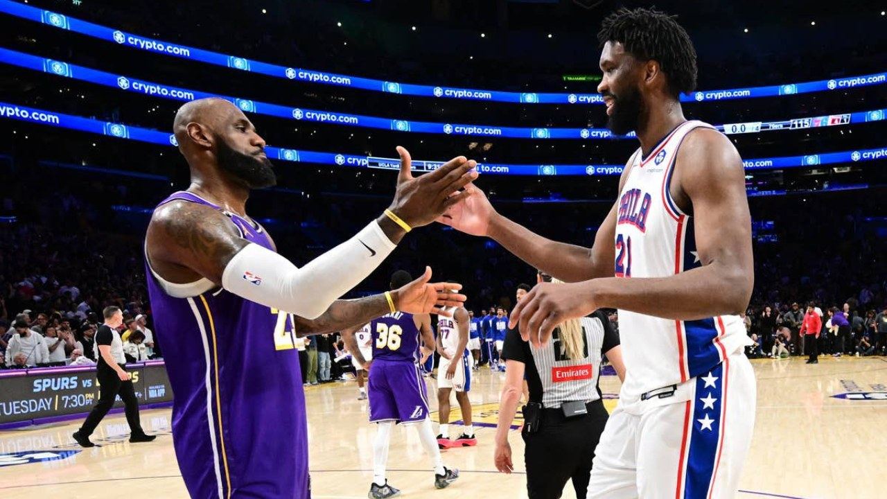 LeBron James and Joel Embiid share a high five as the new 76ers teammates