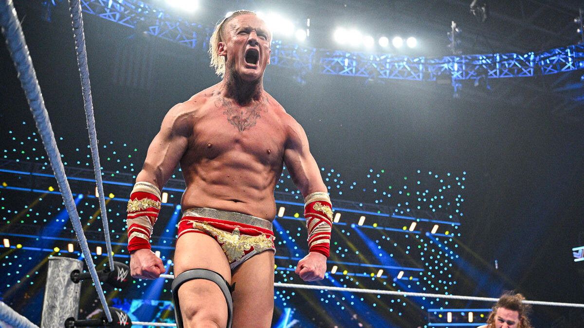 Ilja Dragunov in the ring in his red and gold gear, roaring during his final WWE run