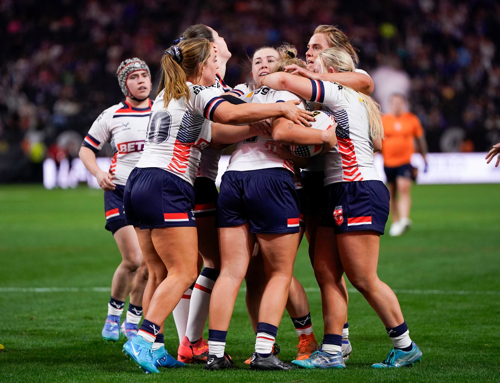 England women players celebrating a try in rugby league action