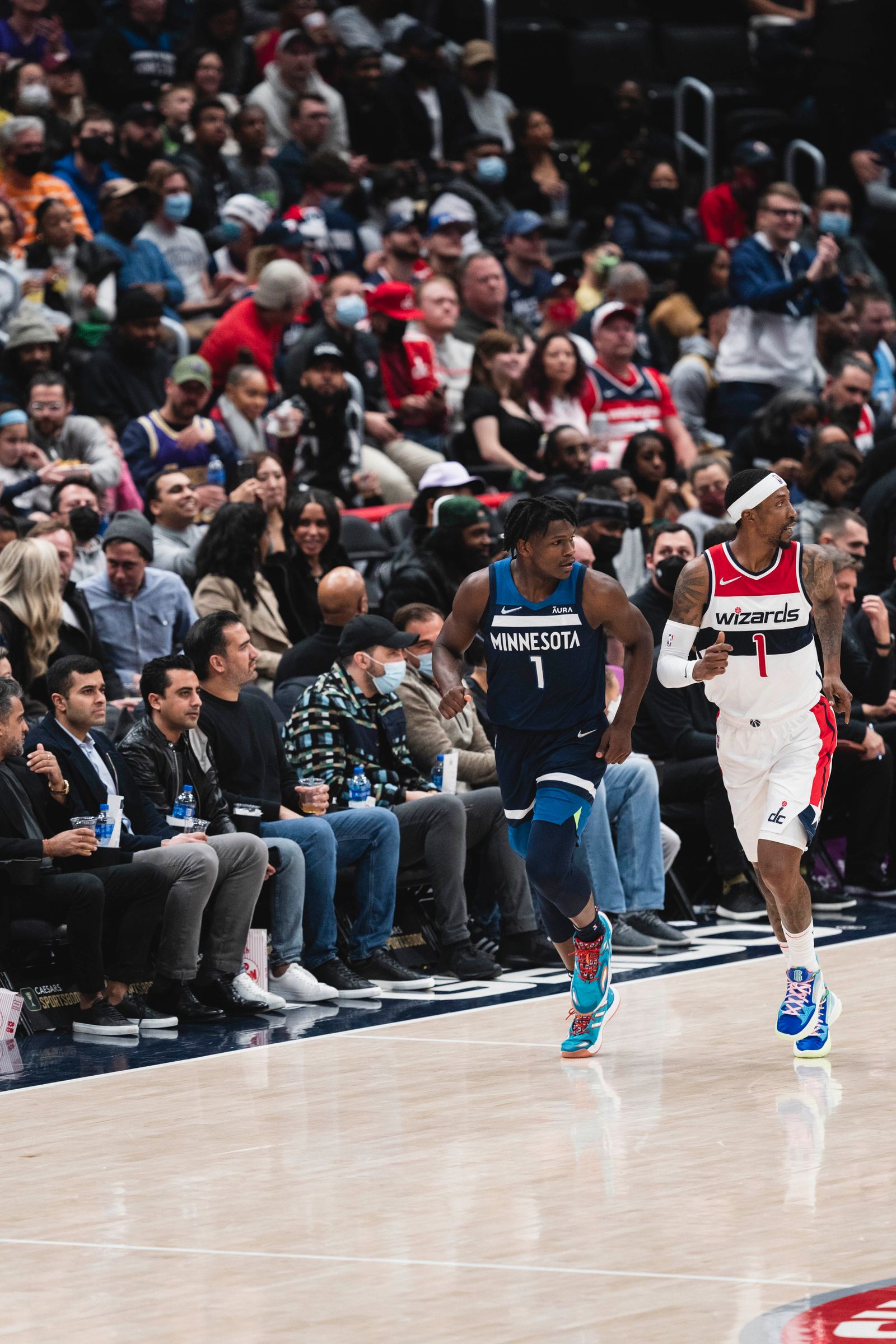 Anthony Edwards drives against Kentavious Caldwell-Pope in a Timberwolves game