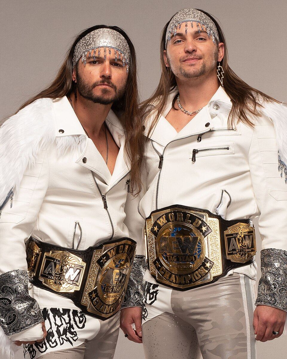 The Young Bucks, Matt and Nick Jackson, posing with the AEW World Tag Team Championship