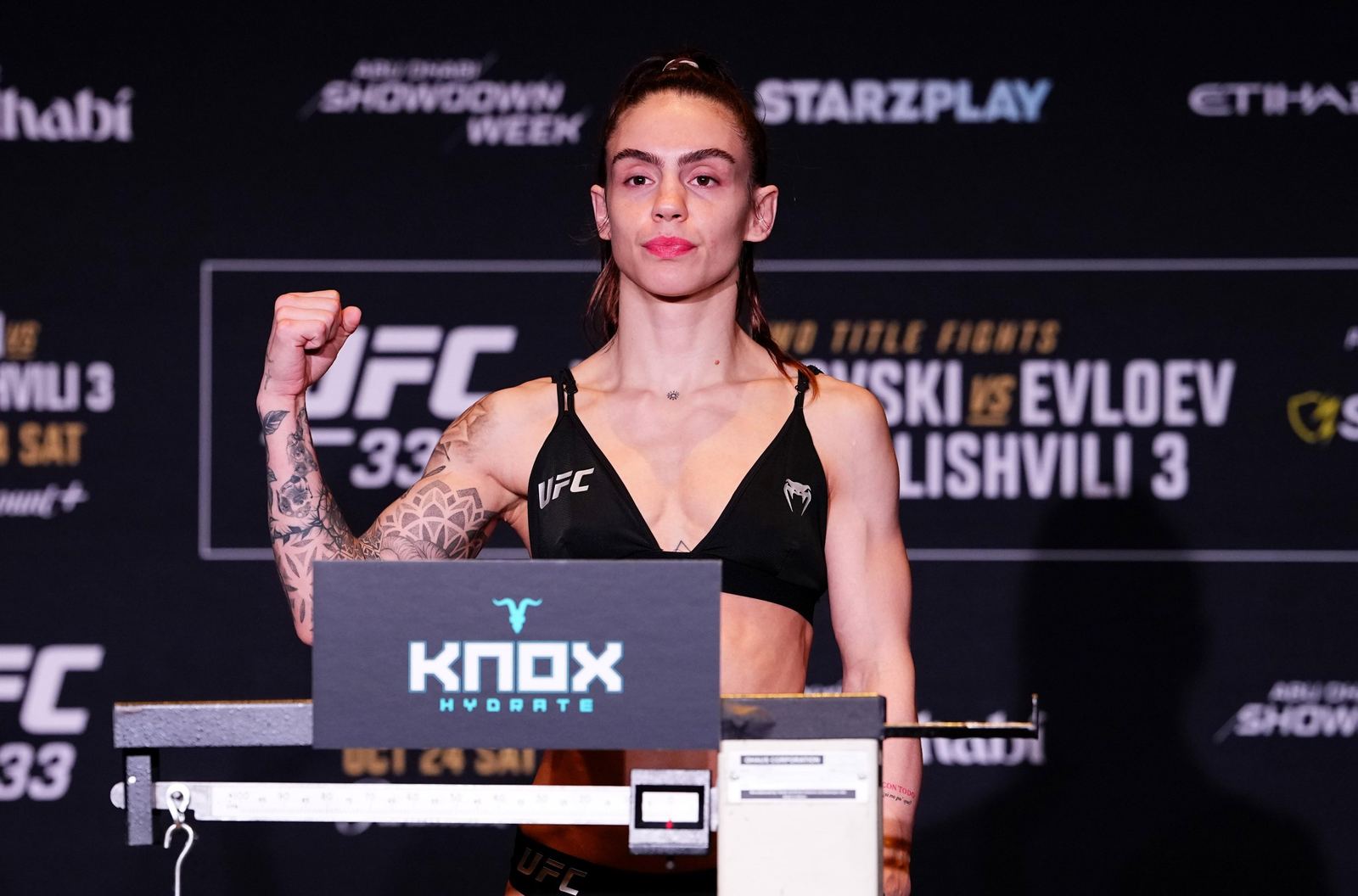Nicolle Caliari poses on the scale during the UFC 333 official weigh-ins in Abu Dhabi on October 23, 2026
