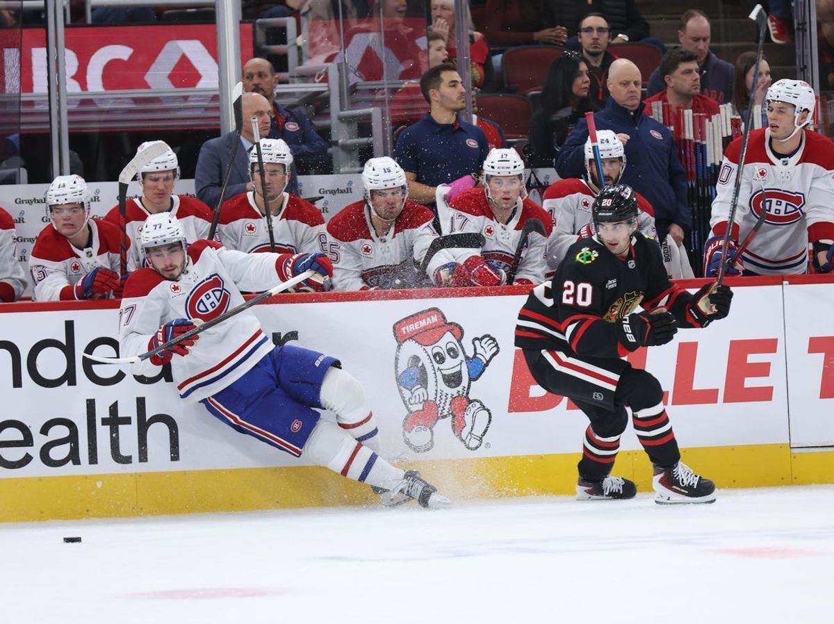 Montreal Canadiens center Kirby Dach and Chicago Blackhawks center Ryan Greene battle for the puck during the first period at United Center on October 23, 2026.