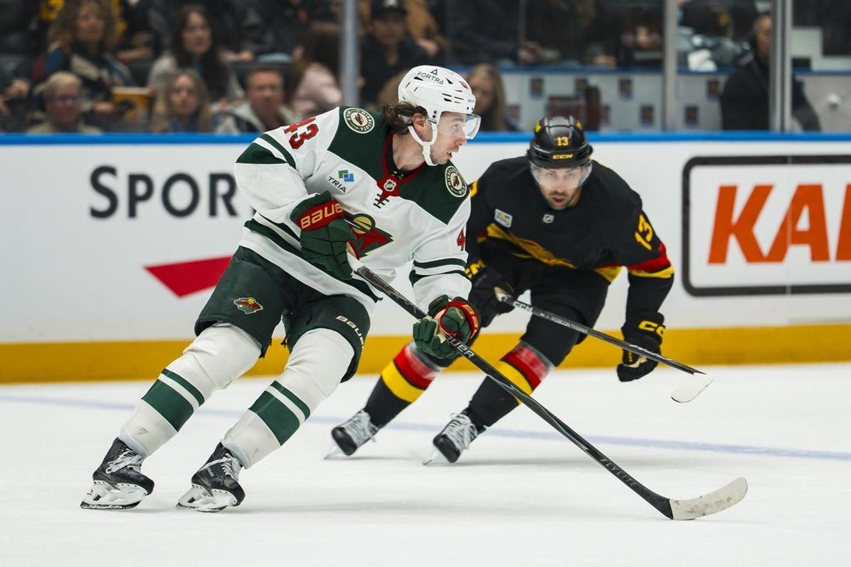 Arshdeep Bains pursues Quinn Hughes in the second period at Rogers Arena on 25 October 2026