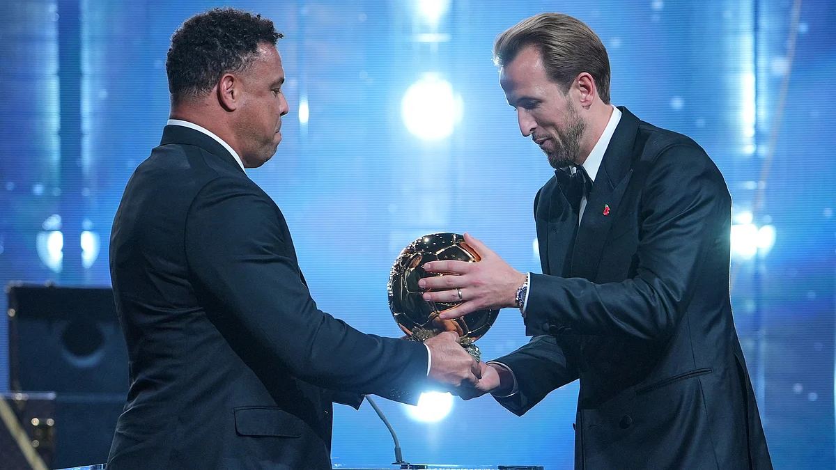 Harry Kane receives the player of the year trophy from Ronaldo Nazario at the London Palladium Ballon dOr ceremony