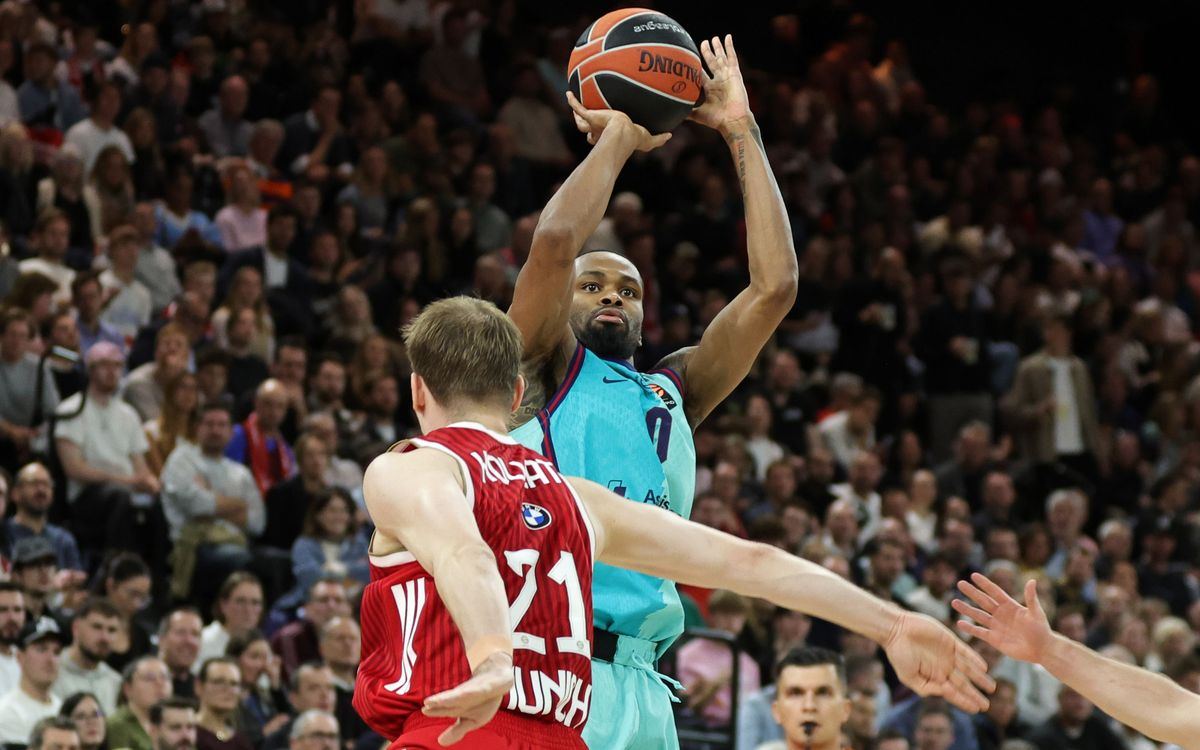 A Barcelona player in the light blue away kit shoots over a Bayern Munich defender in red during the EuroLeague game at SAP Garden in Munich.