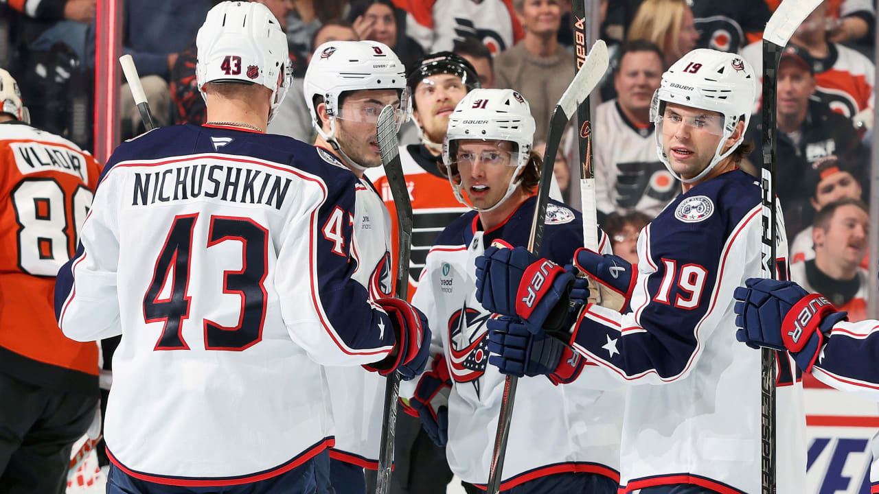 Columbus Blue Jackets players celebrate a goal against the Philadelphia Flyers at Xfinity Mobile Arena on Oct 27, 2026 — hero image of the NHL.com game recap (Dan Vladar in Flyers orange at left)